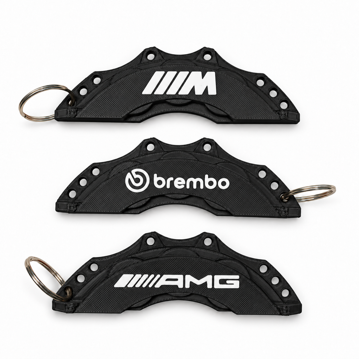 Black and white colour mock-up of M, Brembo and AMG brake caliper keyrings